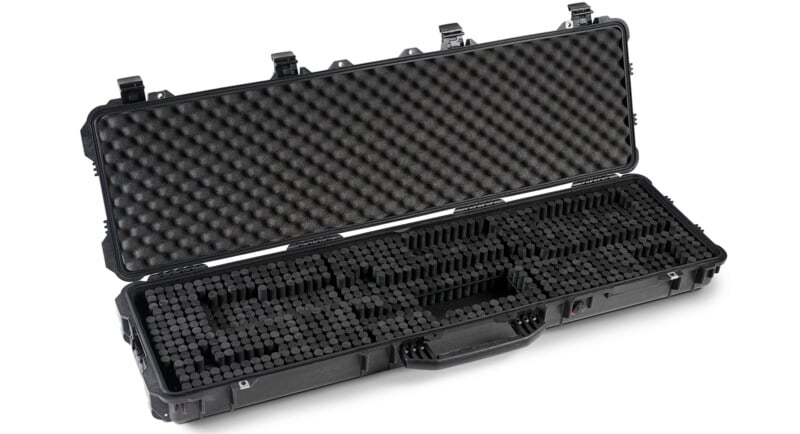 A hard-shell black protective carrying case with egg crate foam in the open lid and customizable foam inserts in the base, designed for securely transporting equipment.