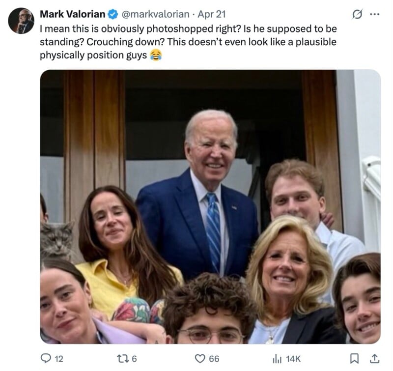 A group of people, including Joe Biden, smile for a photo on a porch. Biden appears taller and awkwardly positioned behind others, as if not standing naturally with the group.