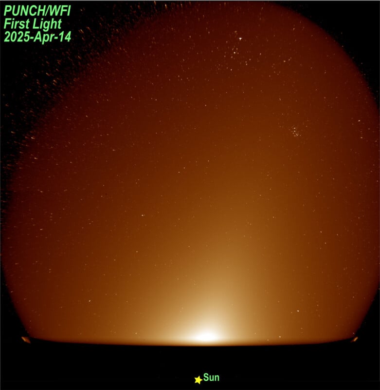 Wide-angle image showing a bright, glowing area labeled "Sun" near the bottom center, with numerous stars visible against a dark, gradient sky. Text reads "PUNCH/WFI First Light 2025-Apr-14" in the top left corner.